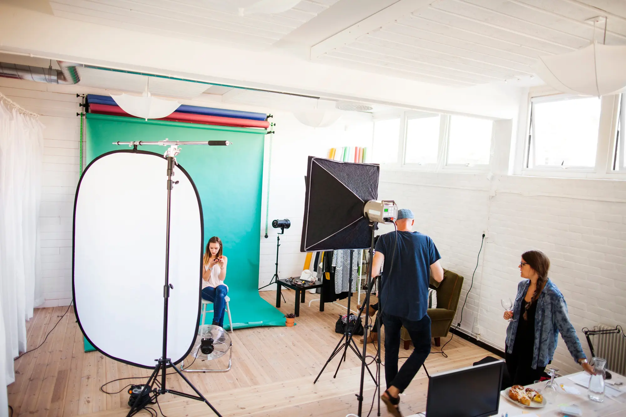 Photographer with assistant and fashion model in studio